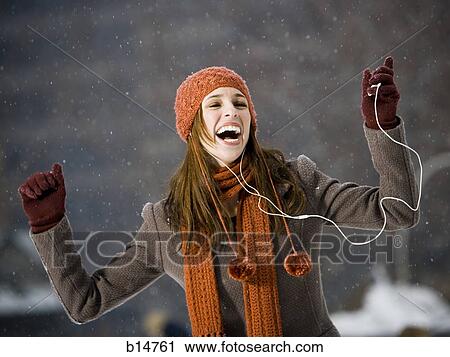 Woman with mp3 player outdoors in winter smiling View Large Photo Image Stock Image - Woman with mp3 player outdoors in winter smiling. Fotosearch