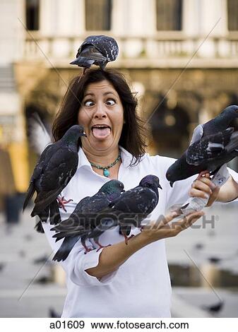 Woman with pigeons and eyes crossed with tongue out View Large Photo Image Stock Photo - Woman with pigeons and eyes crossed with tongue out. Fotosearch