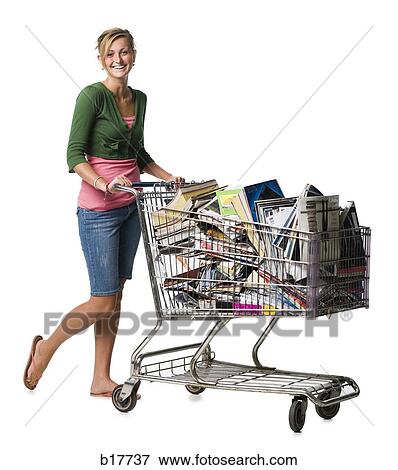 Woman with shopping cart filled with books smiling View Large Photo Image Stock Photo - Woman with shopping cart filled with books smiling. Fotosearch