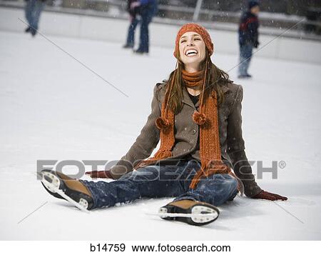 Woman with skates sitting on ice smiling View Large Photo Image Stock Photo - Woman with skates sitting on ice smiling. Fotosearch
