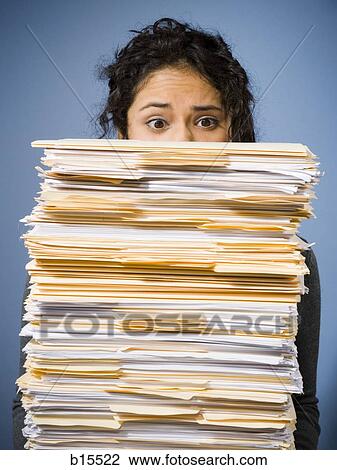 Woman with stacks of paperwork View Large Photo Image Stock Image - Woman with stacks of paperwork. Fotosearch