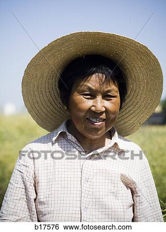 Woman with straw hat in field outdoors View Large Photo Image Stock Photograph - Woman with straw hat in field outdoors. Fotosearch