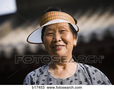 Woman with sun visor outdoors smiling View Large Photo Image Stock Image - Woman with sun visor outdoors smiling. Fotosearch