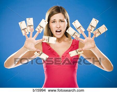 Woman with ten mousetraps on fingers and thumbs View Large Photo Image Picture - Woman with ten mousetraps on fingers and thumbs. Fotosearch