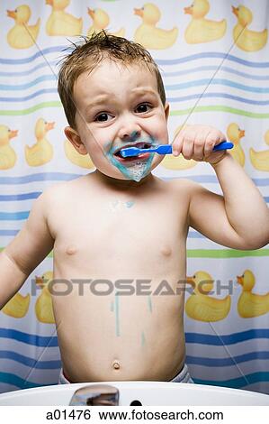 Young boy brushing teeth in bathroom sink View Large Photo Image Stock Photograph - Young boy brushing teeth in bathroom sink. Fotosearch