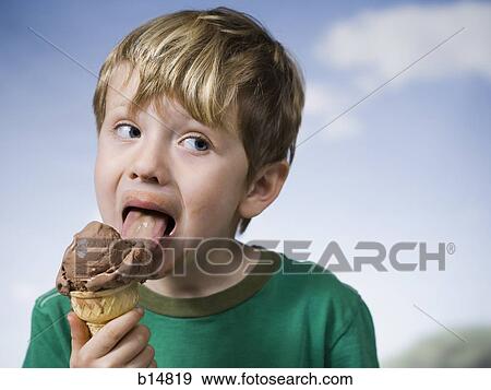 Young boy eating chocolate ice cream cone View Large Photo Image Stock Photo - Young boy eating chocolate ice cream cone. Fotosearch
