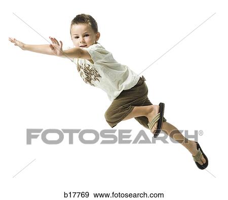 Young boy flying through the air. View Large Photo Image Stock Photo - Young boy flying through the air.. Fotosearch