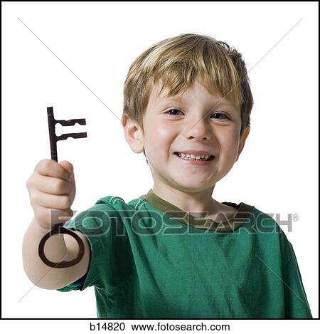 Young boy holding skeleton key smiling View Large Photo Image Stock Image - Young boy holding skeleton key smiling. Fotosearch