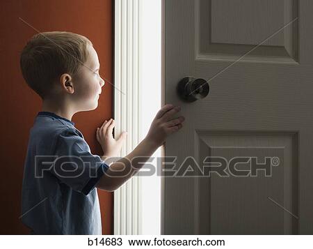 Young boy looking through doorway View Large Photo Image Stock Image - Young boy looking through doorway. Fotosearch