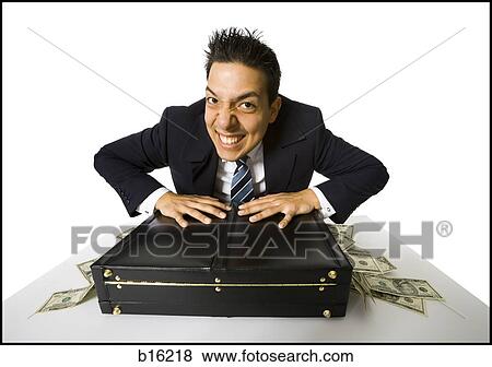 Young businessman with banknotes falling out of briefcase View Large Photo Image Stock Photo - Young businessman with banknotes falling out of briefcase. Fotosearch