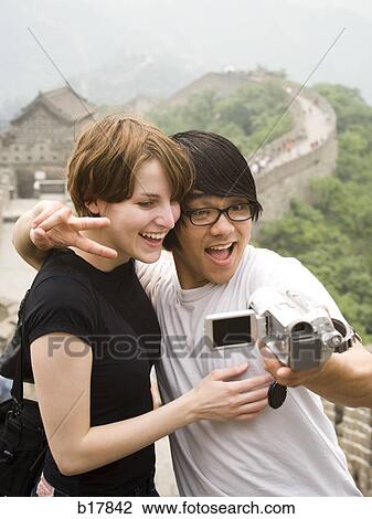 Stock Image - Young couple at the Great Wall of China.. Fotosearch