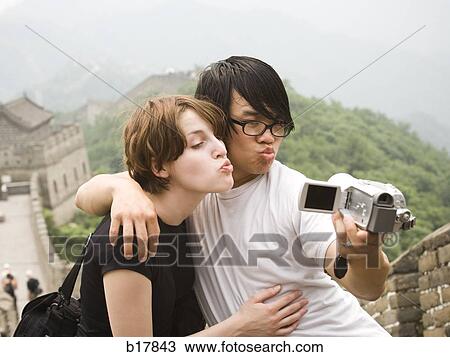 Stock Image - Young couple at the Great Wall of China.. Fotosearch