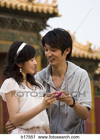 Young couple with mp3 player smiling outdoors View Large Photo Image Stock Image - Young couple with mp3 player smiling outdoors. Fotosearch