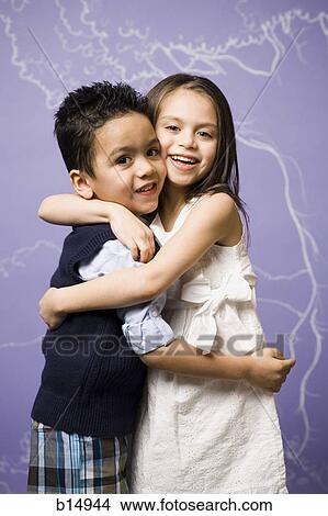 Young girl and boy hugging View Large Photo Image Picture - Young girl and boy hugging. Fotosearch