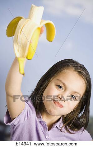 Young girl eating banana View Large Photo Image Stock Image - Young girl eating banana. Fotosearch
