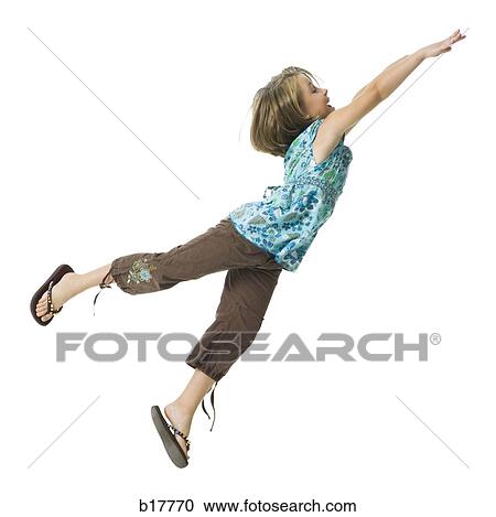 Young girl flying through the air. View Large Photo Image Stock Image - Young girl flying through the air.. Fotosearch