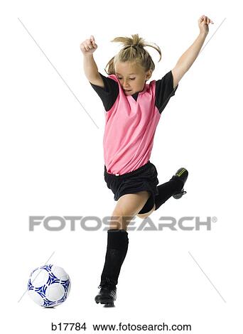 Picture - Young girl in a soccer uniform with ball.. Fotosearch