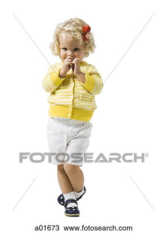 Stock Image - Young girl in a yellow sweater.. Fotosearch