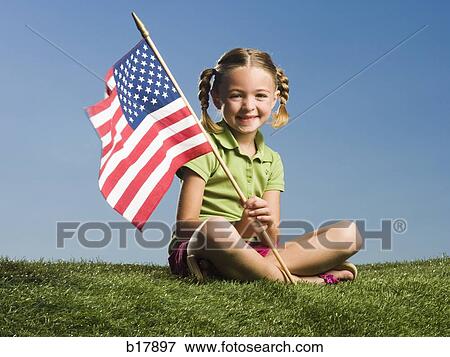 Stock Photo - Young girl on the grass.. Fotosearch