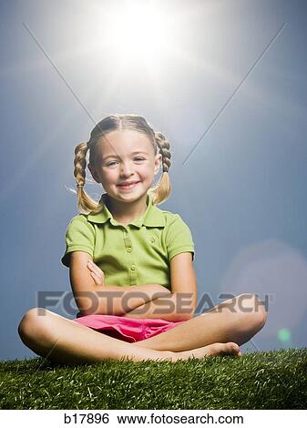 Stock Photograph - Young girl on the grass.. Fotosearch