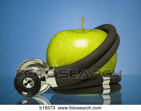 Apple wrapped in a stethopscope. View Large Photo Image Stock Image - Apple wrapped in a stethopscope.. Fotosearch
