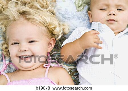 baby boy and little girl lying on a blanket. View Large Photo Image Stock Photo - baby boy and little girl lying on a blanket.. Fotosearch