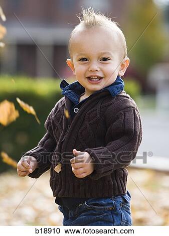 baby boy playing in fallen leaves. View Large Photo Image Stock Image - baby boy playing in fallen leaves.. Fotosearch