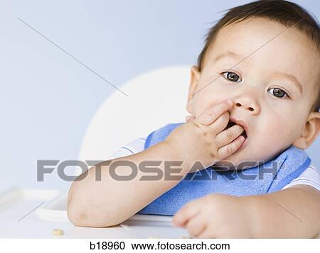 Stock Image - baby boy with a blue bib.. Fotosearch
