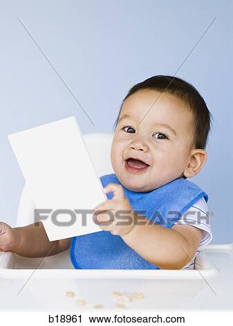 Stock Image - baby boy with a blue bib.. Fotosearch