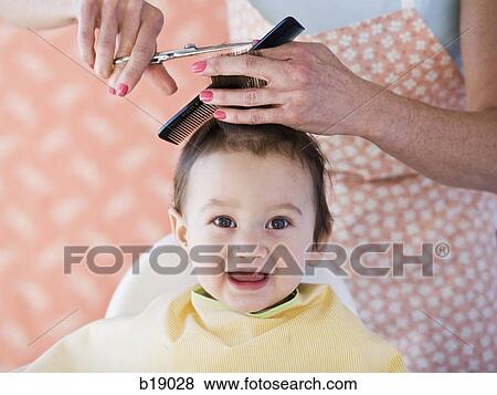 Stock Photo - Baby getting a haircut.. Fotosearch