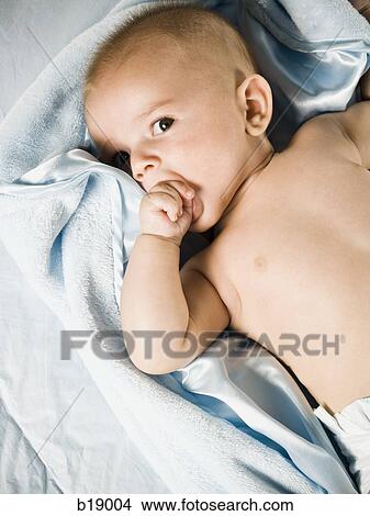 Picture - baby on a blue blanket.. Fotosearch