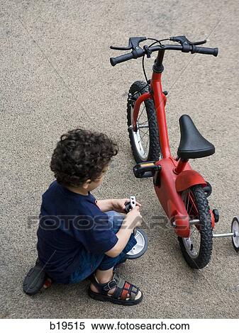 boy fixing his bike View Large Photo Image Stock Photography - boy fixing his bike. Fotosearch
