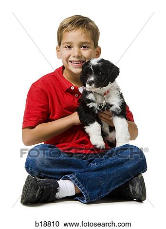 boy in a red shirt holding a puppy. View Large Photo Image Stock Image - boy in a red shirt holding a puppy.. Fotosearch