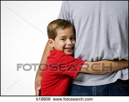 boy in a red shirt hugging a man. View Large Photo Image Stock Photo - boy in a red shirt hugging a man.. Fotosearch