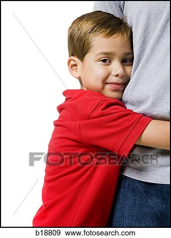boy in a red shirt hugging a man. View Large Photo Image Stock Photo - boy in a red shirt hugging a man.. Fotosearch
