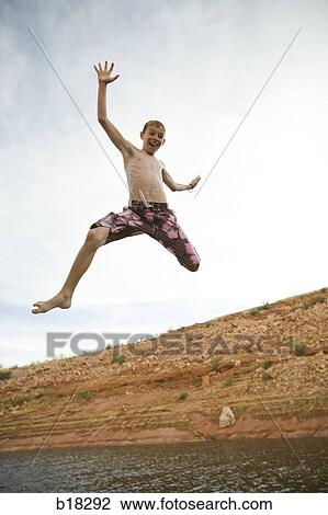 Boy jumping into a lake. View Large Photo Image Stock Image - Boy jumping into a lake.. Fotosearch