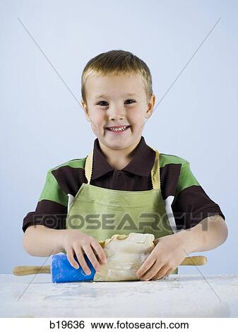 boy kneading dough View Large Photo Image Stock Photograph - boy kneading dough. Fotosearch