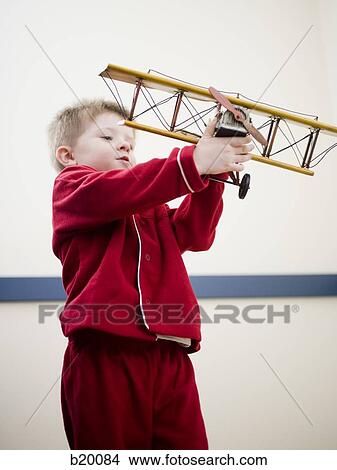 boy playing with a toy plane View Large Photo Image Picture - boy playing with a toy plane. Fotosearch