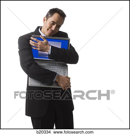 businessperson holding a laptop computer View Large Photo Image Picture - businessperson holding a laptop computer. Fotosearch