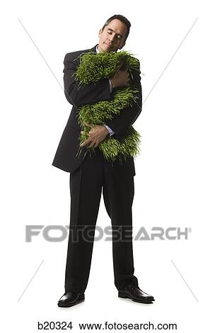 businessperson holding a patch of grass View Large Photo Image Picture - businessperson holding a patch of grass. Fotosearch