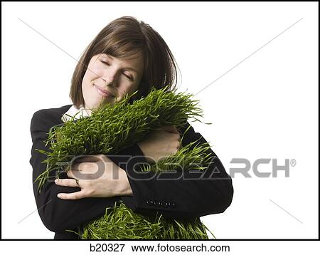 businessperson holding a patch of grass View Large Photo Image Stock Photo - businessperson holding a patch of grass. Fotosearch
