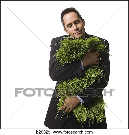 businessperson holding a patch of grass View Large Photo Image Stock Photography - businessperson holding a patch of grass. Fotosearch