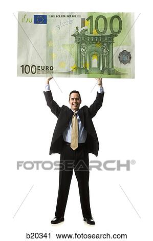 businessperson holding up a bank note View Large Photo Image Stock Image - businessperson holding up a bank note. Fotosearch