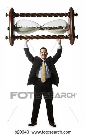 businessperson holding up an hourglass View Large Photo Image Stock Image - businessperson holding up an hourglass. Fotosearch