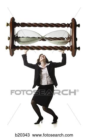 Stock Image - businessperson holding up an hourglass. Fotosearch