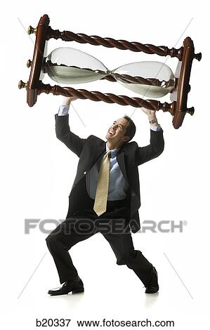 businessperson holding up an hourglass View Large Photo Image Stock Photo - businessperson holding up an hourglass. Fotosearch