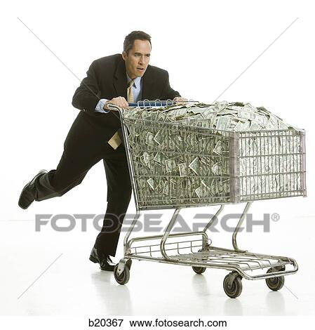 businessperson with a shopping cart full of money View Large Photo Image Stock Photo - businessperson with a shopping cart full of money. Fotosearch