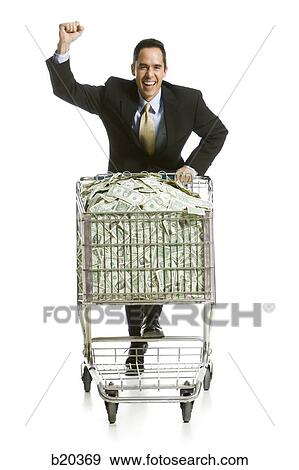 businessperson with a shopping cart full of money View Large Photo Image Stock Photo - businessperson with a shopping cart full of money. Fotosearch
