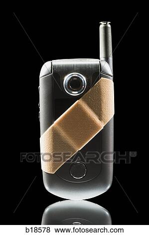 Cell phone with a Band-aid on it. View Large Photo Image Stock Photo - Cell phone with a Band-aid on it.. Fotosearch