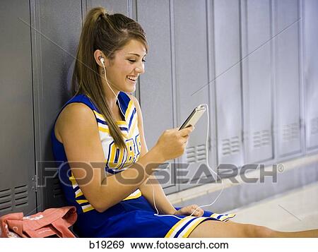Stock Photo - cheerleader in a school hallway. Fotosearch